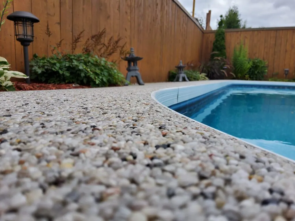 Resin bound stone surround on a backyard pool patio